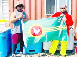 Two men in Alaska holding the Manu'a flag
