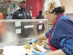 Congresswoman Aumua Amata dishing up food for troops