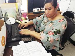 DMWR employee inputting data.
