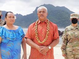 Two soldiers in uniform in the background during the American Samoa roll call at the DNC