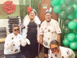 Cruella is having a grand time with her Dalmatians