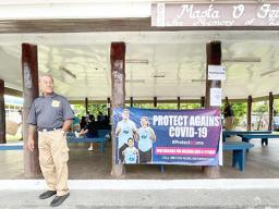 Man standing in front ofSamoa Baptist Academy’s Samoan fale 