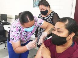Med staff administering a covid-19 vaccination