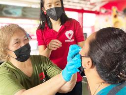 A teacher learning how to administer rapid COVID test