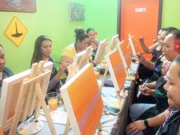 A group of friends each painting a picture
