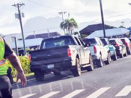 An  Airport Police officer monitoring traffic at drive-thru vax clinic
