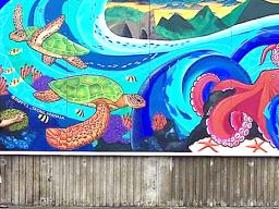 Duffy Hudson next to his mural