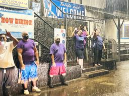 StarKist employees waving for Domestic Violence Awareness Month in the rain