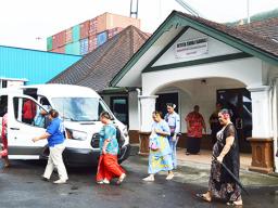 ECE teachers walking toward a van to go to the residence of the ECE Director in Vaitogi