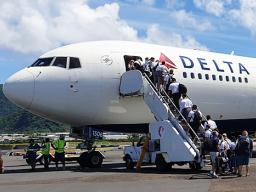 The last of the 29 missionaries of the Church of Jesus Christ of Latter Day Saints boarding the Delta Air Lines charter flight