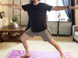 In this March 19, 2020, photo made available by Steve Latart, Latard does yoga exercises at his home in Rogers, Minn.