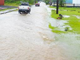 Car attempting to drive through flood waters in Fagaima
