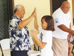 FFAS president, Sen. Faiivae Iuli Alex Godinet, high fives a player on