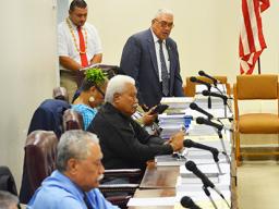 Four representatives at their desks