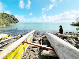 Eseta Vusamu sits near the water