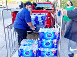 Cases of water on a dolly