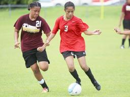 A Faga’itua player (right), dribbles against a Tafuna opponent 