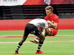 Canada’s Luke McCloskey is pummeled by Fiji’s Aminiasi Tuimaba
