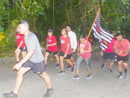 Members of the community march to honor fallen firefighters