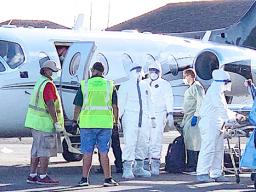 Ground crew and medical personnel on the tarmac at the Pago Pago International Airport 