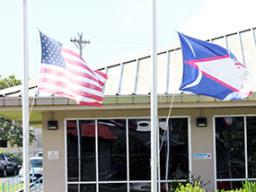 American Samoa and U.S. flags at half staff