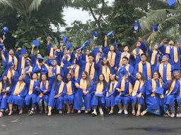 Fa’asao Marist High School 2020 graduates throwing caps in the air