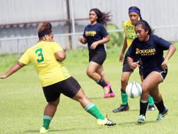 A Cougars player (right) dribbling away from a Leone defender during