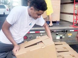 Ā’oga Samoa boys unloading cartons of food