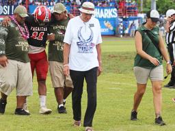 ASHSAA ATC Florence Wasko (right) and Dr. Edwards leading off the injured Manuita Sofeni of