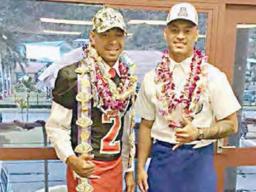 Steven Fiso (left) of Faga’itua High School who signed on with the University of Hawaii, and Eddie Siaumau (right) of Fa’asao Marist High School who signed with the University of Arizona.