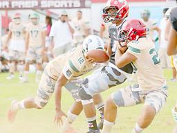 Scott Pese is brought down by two Team Fealofani defenders