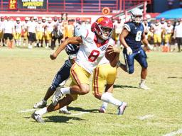 Tafuna Warriors quarterback Oakland Salave’a scrambling through midfield 