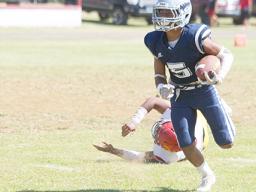 Samoana Sharks Sophomore at running back, Marcus Samia beating a Tafuna defender