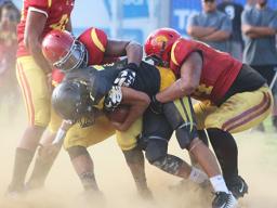Nu’uuli Wildcats quarterback Nathaniel Maea is swallowed in the backfield for a loss by