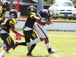Avory Seumanutafa of the Blue Empire dragging a defender with him 