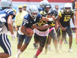 Samoana Sharks quarterback Viliamu Tanielu stiff arms a Nu’uuli Wildcat defender 