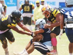 Charlie Toa Leama of Nu’uuli and a teammate sack Samoana’s quarterback Viliamu Tanielu
