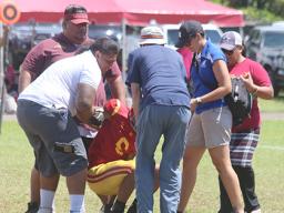 ASHSAA ATC Florence Wasko and Dr. Edwards helping Tafuna Warriors wide receiver Isaiah Gurr