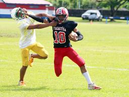 Faga’itua Viking’s Scott Pese (10) puts a stiff arm to the face of a Leone defender