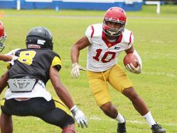 Tafuna Warriors’ John Allen (10) tries to evade a Nu’uuli Wildcat