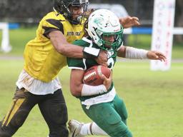 Freshman running back for Leone, Wylan Faga is tackled