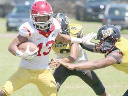Tafuna’s ball carrier trying to evade the pressure from two Nu’uuli Wildcat defenders