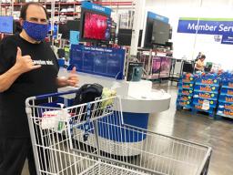 Frank De Lima pushing a shopping cart and giving shaka sign