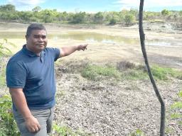 Mayor Jeff Adalbai looks at the water level 