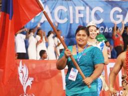 Samoan weightlifter Feagaiga Stowers carrying Samoa flag