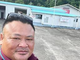 Faipule Luaitaua Gene Pan in front of the Fagaitua East Substation