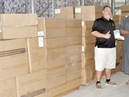 Gov. Lemanu Peleti Palepoi Sialega Mauga with Ziggy Vollrath and cartons of PPE