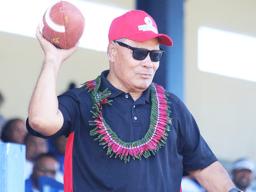 Gov. Lolo Matalasi Moliga passing football to open 2018 ASHSAA season