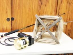 hand cranked reel beside an electric reel