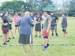 Coach CJ Sagapolutele Floor instructing Pacific Horizons School students
